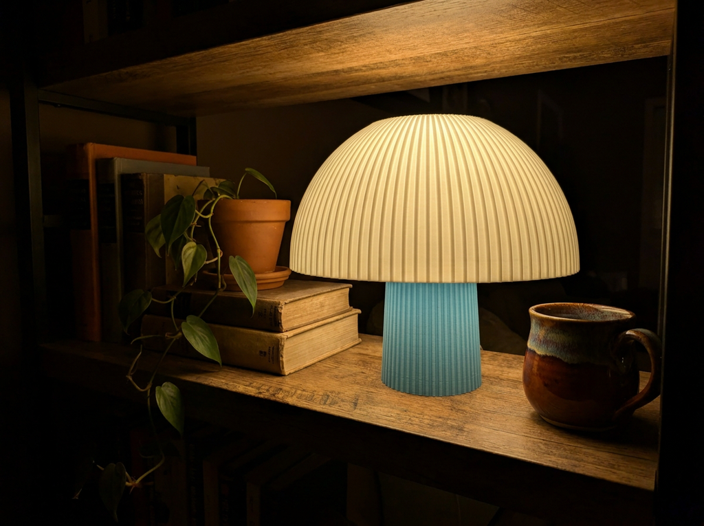 Mushroom lamp glowing on a wooden shelf in a dark living room at night